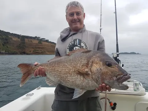 2021 '2 Grander' - member with a big snapper on a grey day in the Gulf